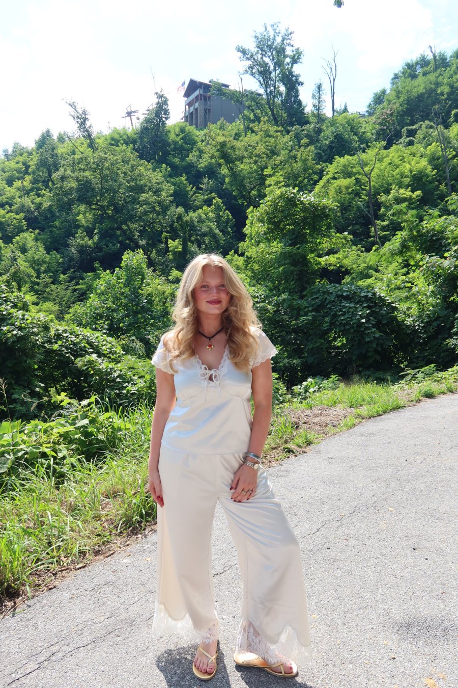Madeline Secker in a cream satin top and lace-trimmed wide-leg pants
